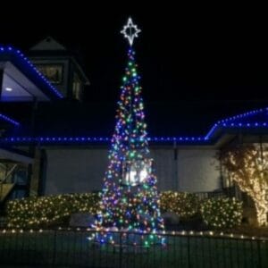 21 ft commercial Christmas LED Tree of Lights with multicolor lights installed outdoors at night