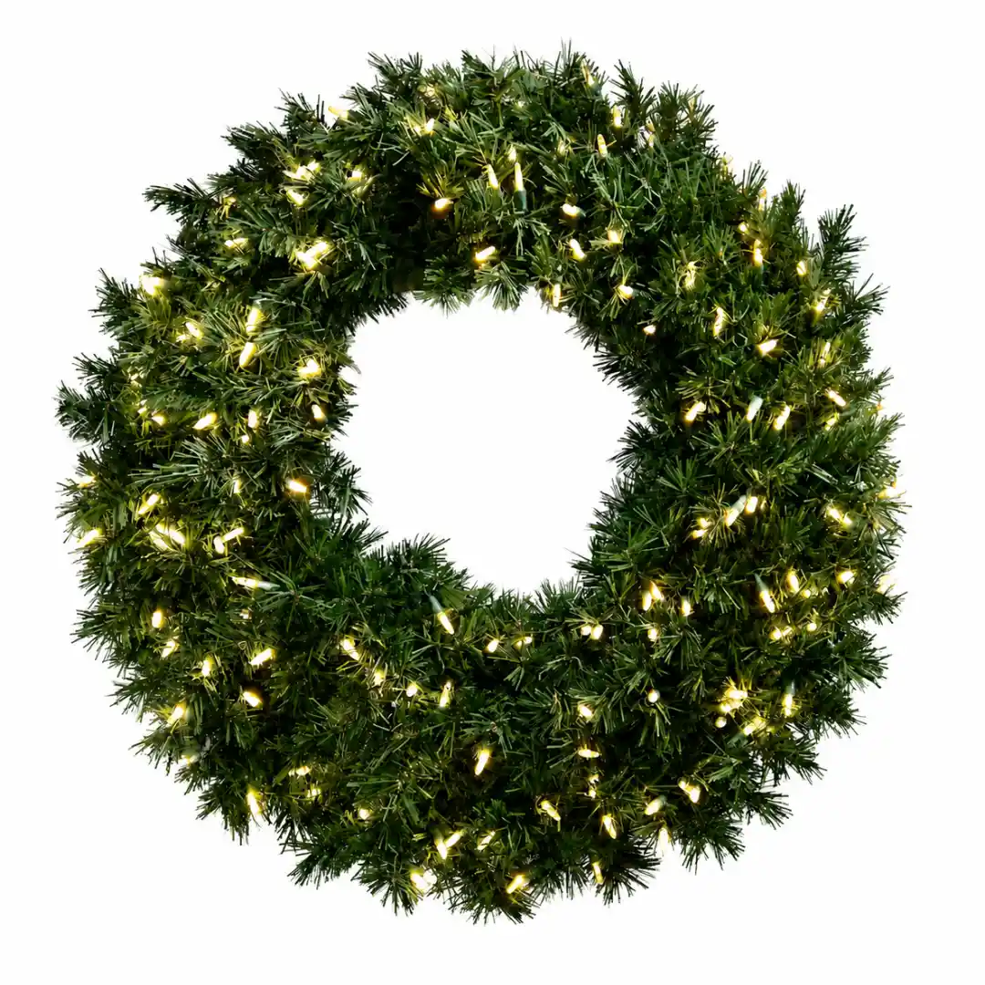 Green Christmas wreath illuminated with warm white lights