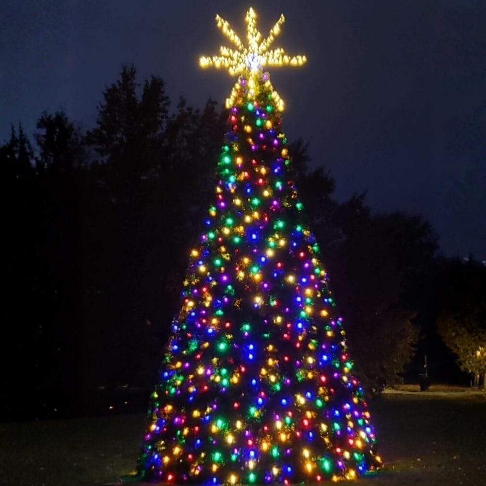 14-foot commercial Christmas panel tree with multicolor lights installed outdoors at night
