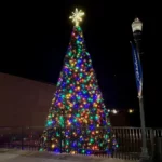 18-foot commercial Christmas panel tree with multicolor lights installed outdoors at night