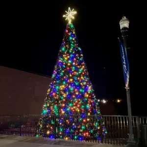 18-foot commercial Christmas panel tree with multicolor lights installed outdoors at night