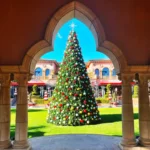 22-foot commercial Christmas panel tree with red, gold, and silver ornaments installed in an outdoor plaza