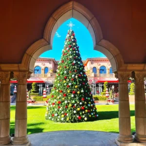 22-foot commercial Christmas panel tree with red, gold, and silver ornaments installed in an outdoor plaza