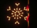 3-foot standard snowflake pole mount holiday light display illuminated on a pole at night