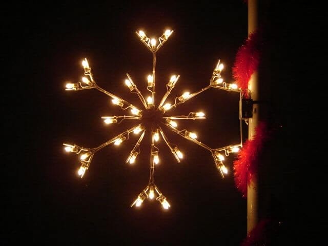 3-foot standard snowflake pole mount holiday light display illuminated on a pole at night