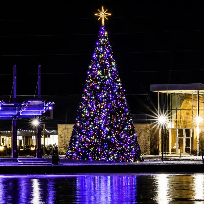 34-foot commercial Christmas panel tree with multicolor lights installed outside a commercial property at night