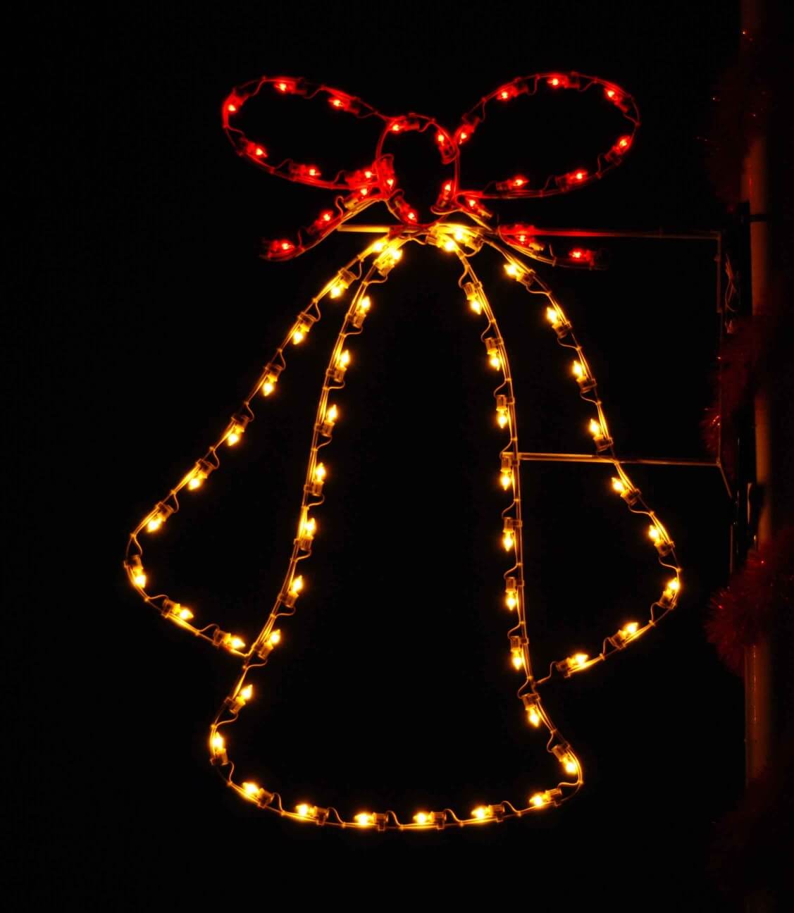 5-foot Triple Bell pole mount holiday light display illuminated on a pole at night