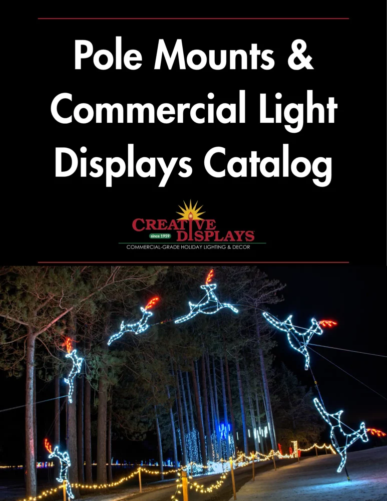 Lighted reindeer arch over driveway at night
