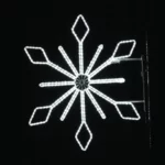 A glowing snowflake shines brightly against the night. Its crisp white lights create a festive winter display.