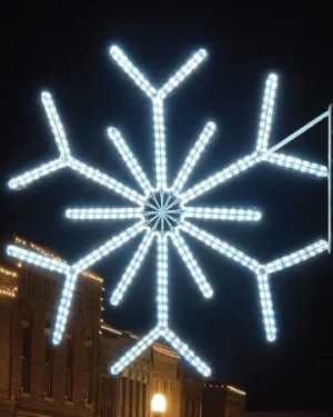 Illuminated snowflake street decoration at night