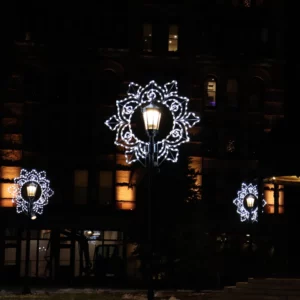 Street lamps with snowflake lights at night