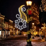 Holiday street with illuminated snowflake and wreath