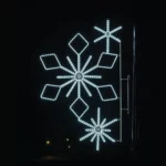 Illuminated snowflake street decoration at night