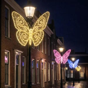 Illuminated butterfly decorations on street lamps at night