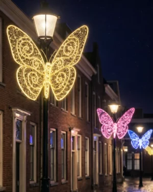 Illuminated butterfly decorations on street lamps at night