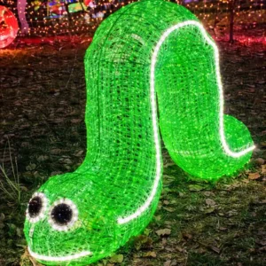 Glowing green worm light sculpture at night