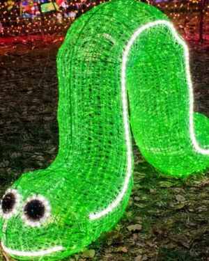 Glowing green worm light sculpture at night