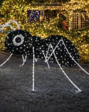 Giant illuminated mosquito decoration in festive garden