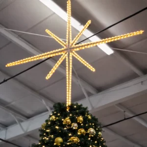 Illuminated star atop decorated Christmas tree indoors