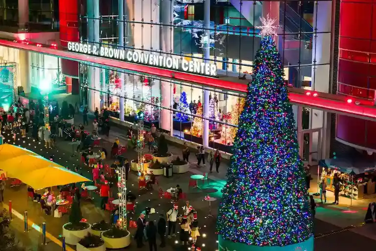 Large Christmas tree outside convention center at night