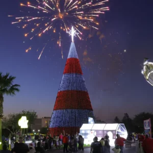 Fireworks over patriotic Christmas tree at night