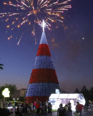 Fireworks over patriotic Christmas tree at night