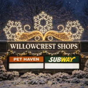 Willowcrest Shops sign with holiday snowflake lights