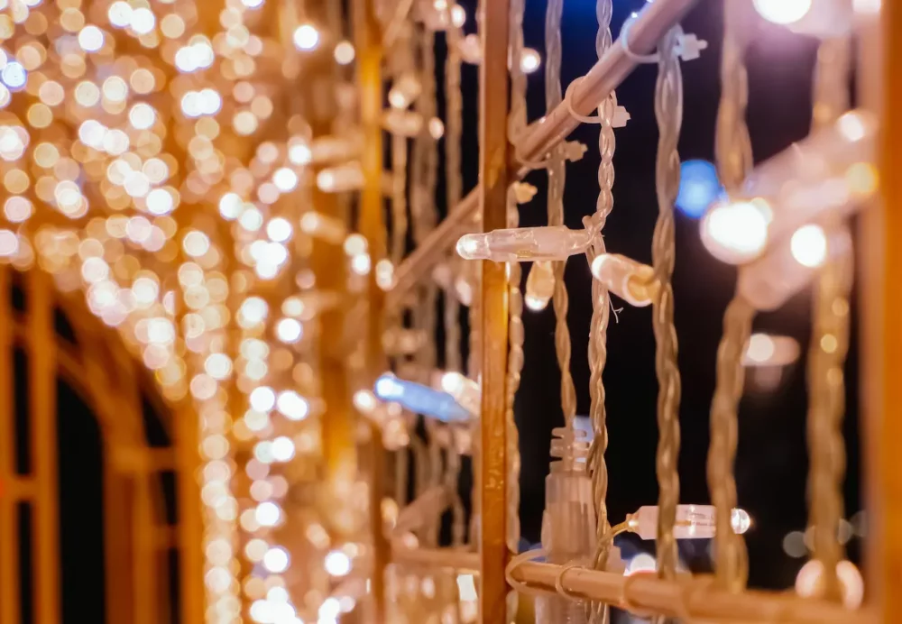 Warm white string lights on railing at night