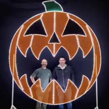 Two men inside giant illuminated jack-o'-lantern selfie commercial halloween decor