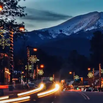 Mountain town street with commercial christmas snowflake light pole decorations