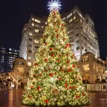 Large illuminated Commercial Tower Christmas tree outside luxury hotel at night