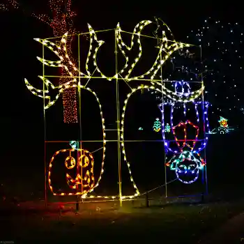 Commercial Halloween light display with tree and pumpkins