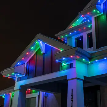 House roofline decorated with colorful Minleon RGB Permanent Lighting