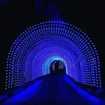 Commercial Christmas RGB light Tunnel lit up in vivid blues and purples on a dark winter night