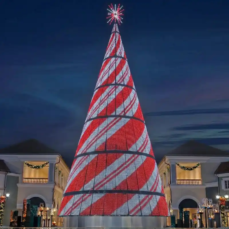 Giant red and white illuminated Christmas tree at night
