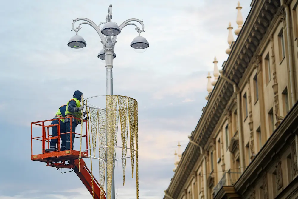 Pole-mounted Christmas decorations lining a busy downtown street