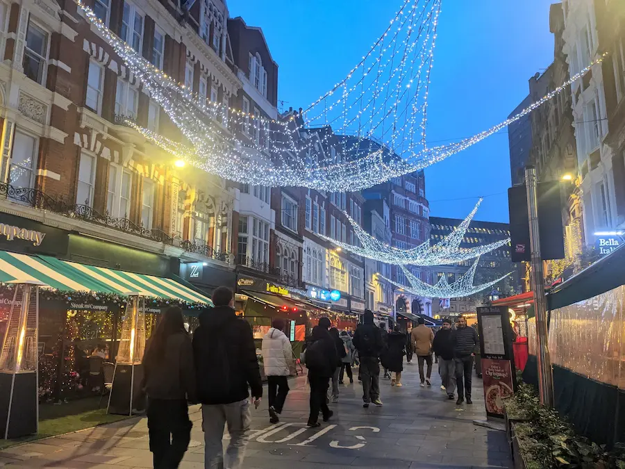Commercial Christmas decorations lighting up a public park at dusk