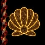 Glowing seashell holiday light on decorated pole