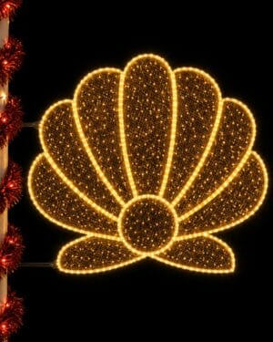 Glowing seashell holiday light on decorated pole