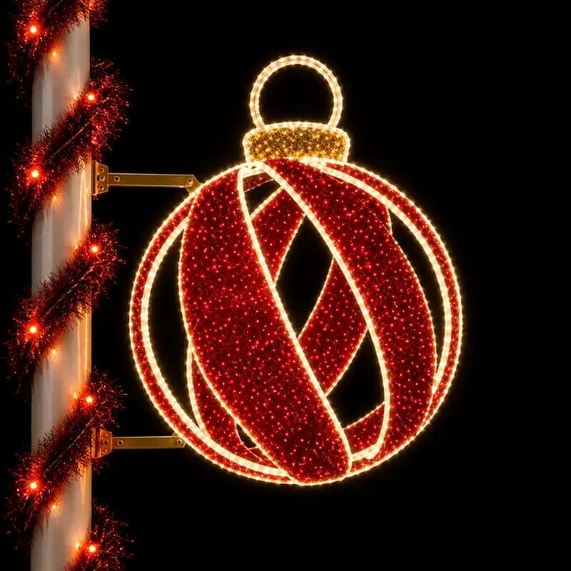 Illuminated red Christmas ornament street decoration at night