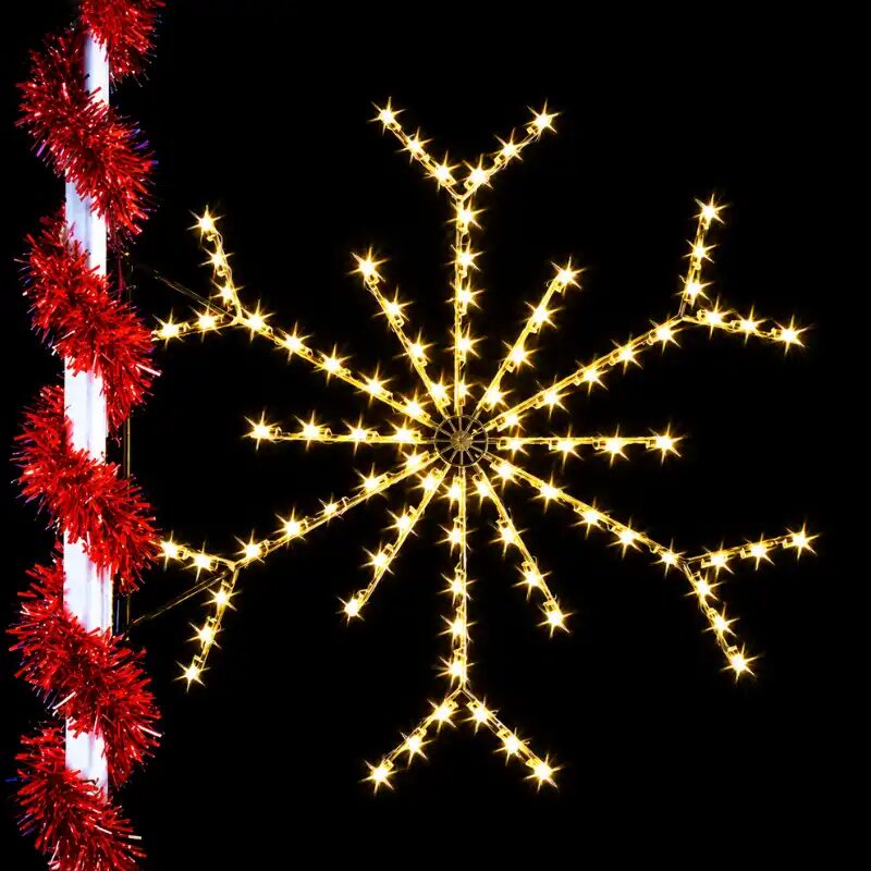 Illuminated snowflake holiday decoration against black background