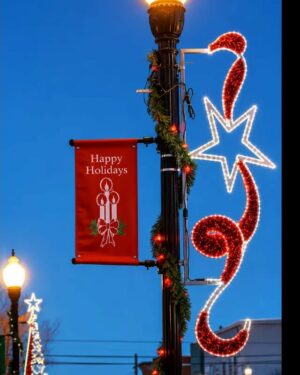 Holiday streetlight with festive banner and star lights