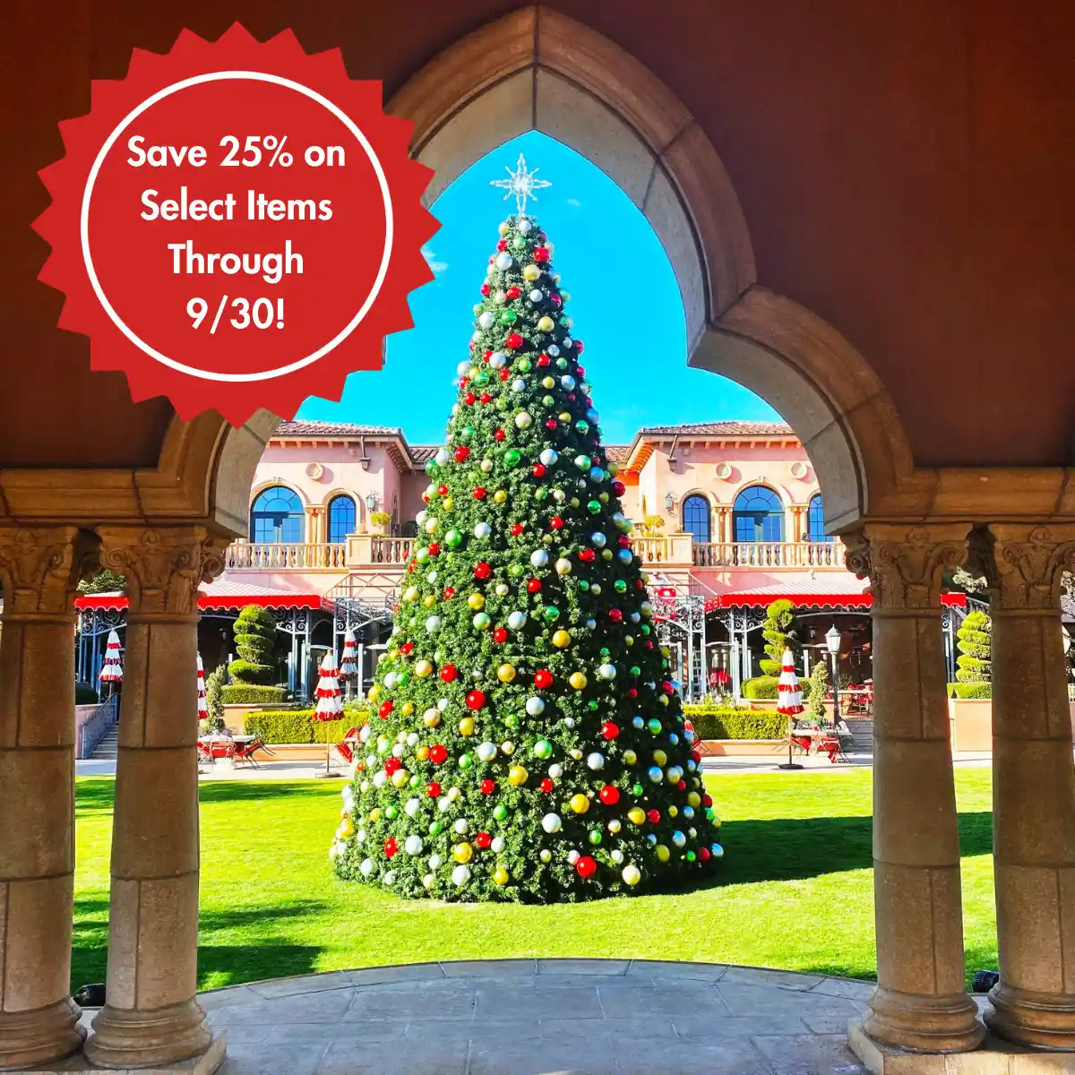 Decorated Christmas tree framed by stone archway and sale badge