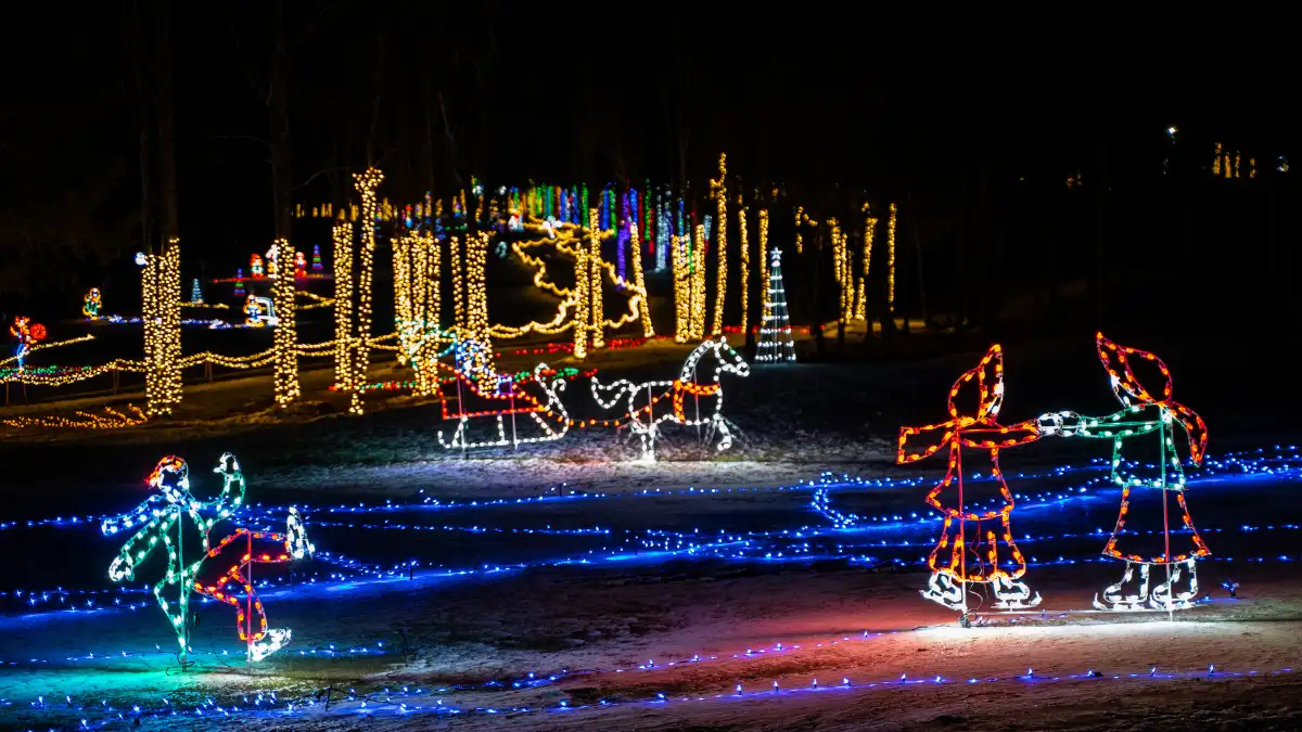 Holiday light display with ice skaters and horses