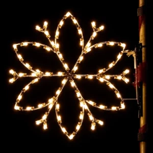 Glowing snowflake light decoration against a dark background