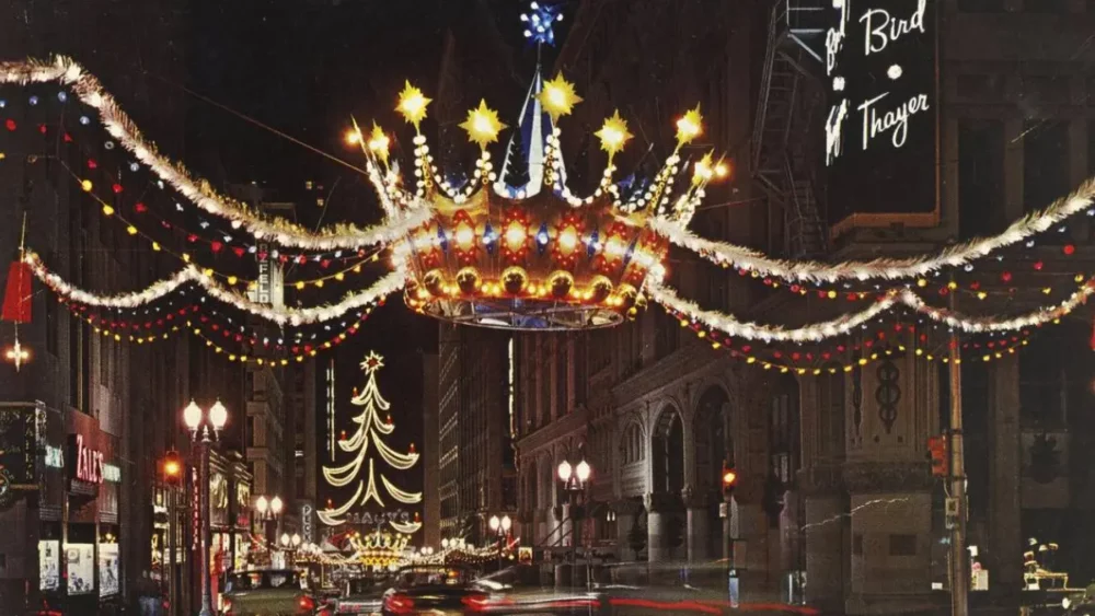 Holiday lights and crown decoration over downtown street